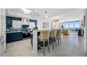 Open-concept kitchen featuring a breakfast bar with seating and views into the living room and ocean at 1325 Snell Isle Ne Blvd # 810, St Petersburg, FL 33704