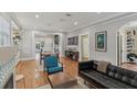 Spacious living room featuring hardwood floors, stylish furniture, and open layout at 1402 E Powhatan Ave, Tampa, FL 33604