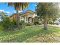 Lush landscaping surrounds this charming home with mature trees and a paver driveway at 15104 Azra Dr, Odessa, FL 33556