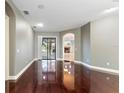 Spacious living room features hardwood flooring and access to a screened outdoor living space at 15104 Azra Dr, Odessa, FL 33556