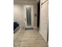 Well-lit foyer with a sliding barn door and a white railing, showcasing the home's entrance at 1600 Still River Dr, Venice, FL 34293