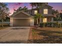 Charming home featuring a two-car garage, well-manicured lawn and mature landscaping at 1605 Acorn Seed Ct, Valrico, FL 33594