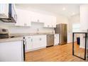 Modern kitchen features white cabinets, stainless appliances, granite counters and modern decor at 1931 Oxnard Ct, Tampa, FL 33612