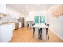 Modern kitchen features white cabinets, stainless appliances, and a large eating area at 1933 Oxnard Ct, Tampa, FL 33612