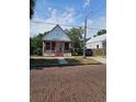 A quaint home with red accents and a brick-paved street at 1935 W Union St, Tampa, FL 33607
