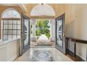 Grand entryway with double doors, tiled floors, and views of the well-manicured front yard at 21215 Preservation Dr, Land O Lakes, FL 34639