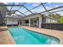 Inviting screened-in pool with brick pavers and covered lanai, perfect for outdoor relaxation and entertaining at 21215 Preservation Dr, Land O Lakes, FL 34639