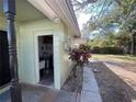 View of home exterior with utility access and mature landscaping near the rear of the property at 2221 York S St, Gulfport, FL 33707