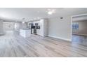Spacious open floorplan featuring kitchen with stainless steel appliances, island, and sleek flooring at 2285 Victory Ave, Largo, FL 33770