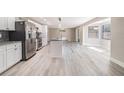 Large kitchen featuring stainless steel appliances, white cabinets, granite countertops, and a spacious open floorplan at 2285 Victory Ave, Largo, FL 33770