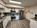 Modern kitchen featuring stainless steel appliances, granite countertops, and sleek gray backsplash at 2434 Australia E Way # 50, Clearwater, FL 33763