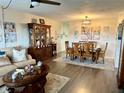 View of a cozy living room and dining area combination with a wooden china cabinet and hardwood flooring at 2434 Australia E Way # 50, Clearwater, FL 33763