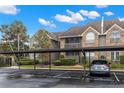 Attractive condo building with reserved parking, brick accents and mature trees at 2500 Winding Creek Blvd # A104, Clearwater, FL 33761
