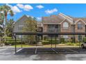 Condo complex with reserved covered parking, multiple units and lush landscaping at 2500 Winding Creek Blvd # A104, Clearwater, FL 33761
