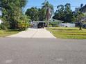 Quaint single-story home with an extra-long driveway nestled within a mature trees at 310 4Th Sw Ave, Ruskin, FL 33570