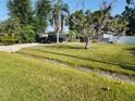 Cozy one-story home featuring a lush green lawn and mature landscaping at 310 4Th Sw Ave, Ruskin, FL 33570
