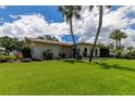 Well-maintained lawn and landscaping add curb appeal to this cozy, single-story home at 3283 Hilary Cir # 2C, Palm Harbor, FL 34684
