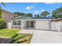 Inviting single-story home featuring a well-maintained front yard and attached one car garage at 3317 W Iowa Ave, Tampa, FL 33611
