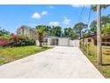Charming single-story home with a long driveway, an attached one car garage and a well manicured lawn at 3317 W Iowa Ave, Tampa, FL 33611