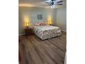Comfortable bedroom featuring wood laminate floors and a stylish ceiling fan with a lamp at 3505 Gloria Ave, Plant City, FL 33563