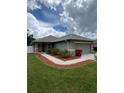 Well-maintained front yard showcasing the exterior of the house with a two car garage at 3505 Gloria Ave, Plant City, FL 33563