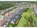 Aerial view of a home with a screened-in pool in a vibrant, planned community at 3850 Bonfire Dr, Odessa, FL 33556
