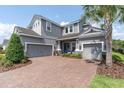 Charming two-story home with a three-car garage and a well-manicured lawn at 3850 Bonfire Dr, Odessa, FL 33556