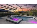 Enclosed pool area with lounge chairs, umbrellas, and jacuzzi, perfect for relaxing at 3850 Bonfire Dr, Odessa, FL 33556