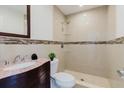 Updated bathroom with a tiled walk-in shower and a stylish vanity with marble countertop at 4902 Murray Hill Drive, Tampa, FL 33615