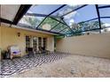 A screened in patio with a graphic outdoor rug and patio furniture at 4908 Rockledge Cir, Tampa, FL 33624