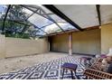Screened-in patio with gravel flooring, outdoor rug, and patio furniture at 4908 Rockledge Cir, Tampa, FL 33624