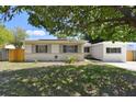 Charming home with landscaped front yard shaded by a mature tree; solar panels installed at 5010 8Th N Ave, St Petersburg, FL 33710