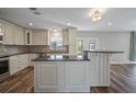 Modern kitchen with stainless steel appliances, granite countertops, a center island, and white cabinetry at 5236 Treig Ln, Wesley Chapel, FL 33545