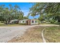 Quaint single-story home with brick accents, surrounded by mature trees and a spacious front yard at 5250 12Th N St, St Petersburg, FL 33703