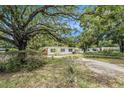 Lovely single-story home nestled among mature trees and lush landscaping, offering a serene setting at 5250 12Th N St, St Petersburg, FL 33703