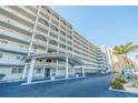 Upscale condo building with multiple levels of balconies and ample parking at 5900 Shore S Blvd # 512, Gulfport, FL 33707
