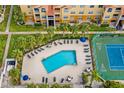 Aerial view of the pool, tennis court, and sun loungers at the Beachway Condominiums at 10764 70Th Ave # 6210, Seminole, FL 33772