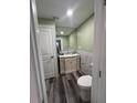 Cozy bathroom boasts a modern vanity, stylish marble backsplash, and wood-look flooring at 11889 Walker Ave, Seminole, FL 33772