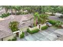 Aerial view of property showcasing roof, driveway, and surrounding mature trees and landscaping at 120 Colony South Dr, Tarpon Springs, FL 34689