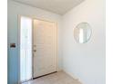 Bright entryway with tile floors, a decorative mirror, and natural light streaming through the side window at 120 Colony South Dr, Tarpon Springs, FL 34689