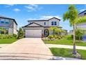 Two story home with well manicured lawn, landscaping, and two car garage in a lakeside community at 12902 Brookside Moss Dr, Riverview, FL 33579