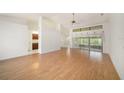 Bright living room with a wall of windows, wood floors and neutral paint at 13819 Stoneridge Dr, Hudson, FL 34669