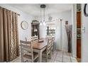 Bright dining room featuring a wood table set, stylish decor, and window providing natural light at 1525 W Comanche Ave, Tampa, FL 33603