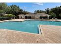 Community pool and lounging area featuring a cabana at 15855 Fishhawk View Dr, Lithia, FL 33547