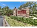 Community entrance sign that reads 'Fishhawk Ridge' nestled among lush greenery at 15855 Fishhawk View Dr, Lithia, FL 33547