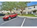 Exterior view of the townhome featuring a red car parked in designated parking spot at 15855 Fishhawk View Dr, Lithia, FL 33547