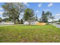 Expansive front yard with lush green grass and a charming fence at 1801 E Navajo Ave, Tampa, FL 33612