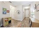 Inviting hallway featuring wood-look floors and decorative wall art at 19323 Hawk Valley Dr, Tampa, FL 33647