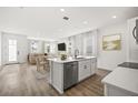Bright, modern kitchen with white cabinetry, stainless steel appliances, and a large island at 2043 Wild Heron Ct, Valrico, FL 33596