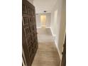 Inviting foyer with decorative front door and luxury vinyl plank flooring at 2205 Belleair Rd # A36, Clearwater, FL 33764
